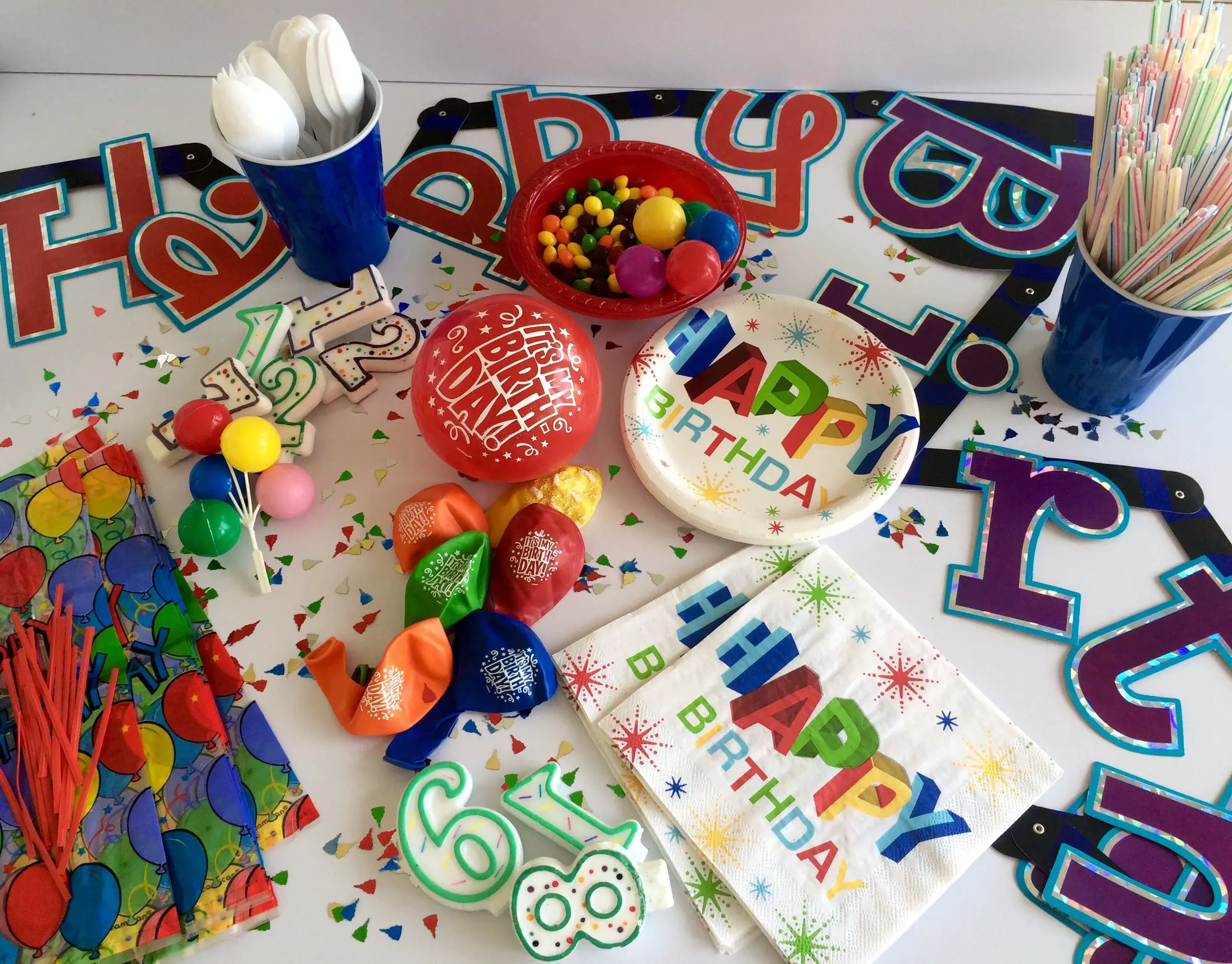 Flat lay of bright colorful birthday party supplies and decorations. Celebrations.